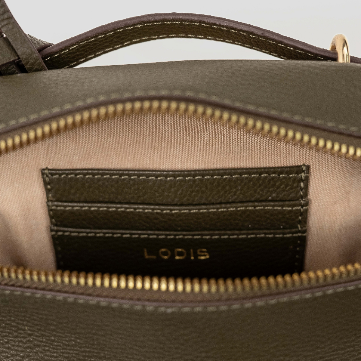 Lodis Stratos Texas Crossbody in Olivine - Interior View Showing Zip-Around Opening, Leather Slip Pocket with Lodis Logo and Light Fabric Lining | Lodis 1965