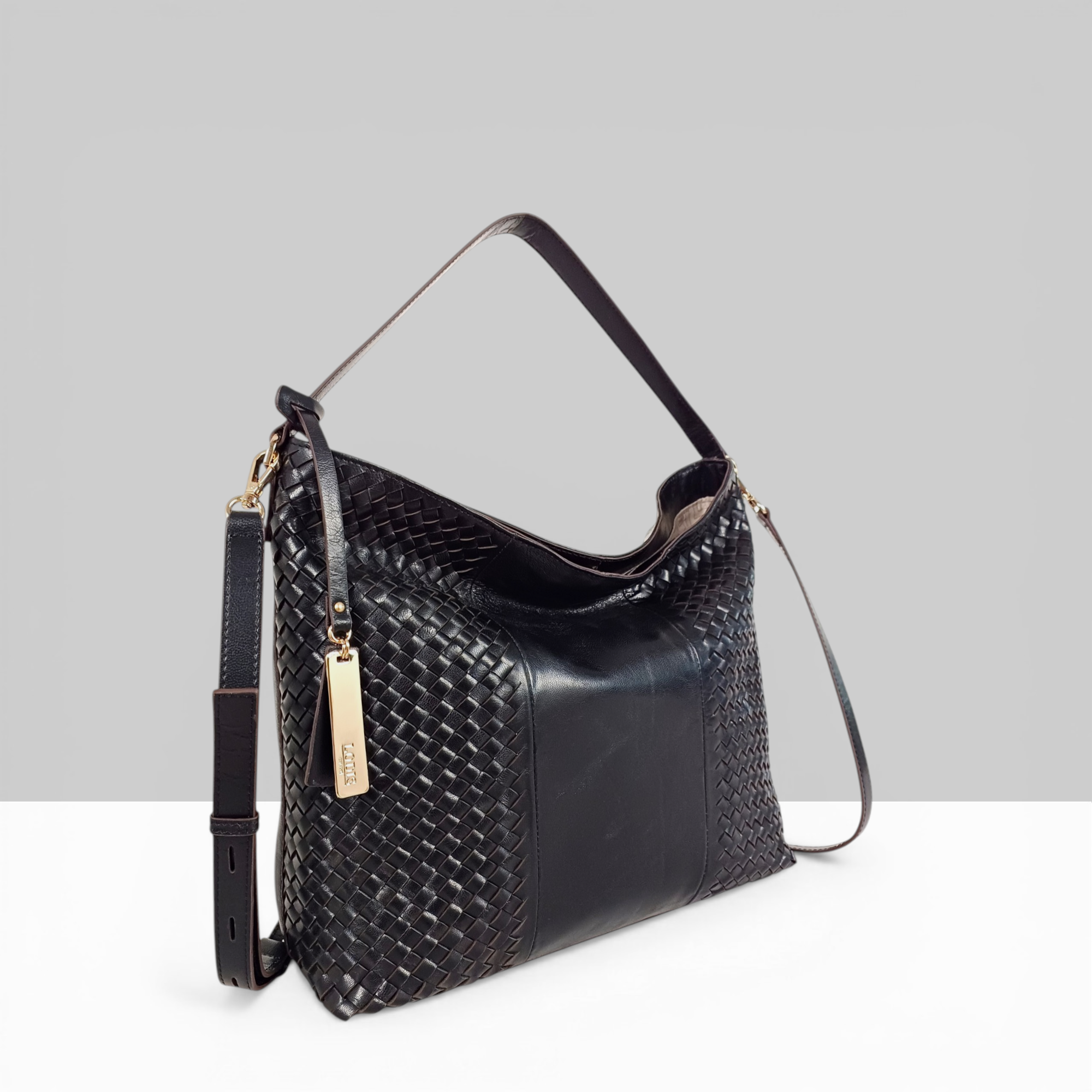 Lodis Venice Hobo in Black – Side Profile View, Polished Woven Genuine Leather with Gold-Tone Logo Tag and Adjustable Crossbody Strap | Lodis 1965