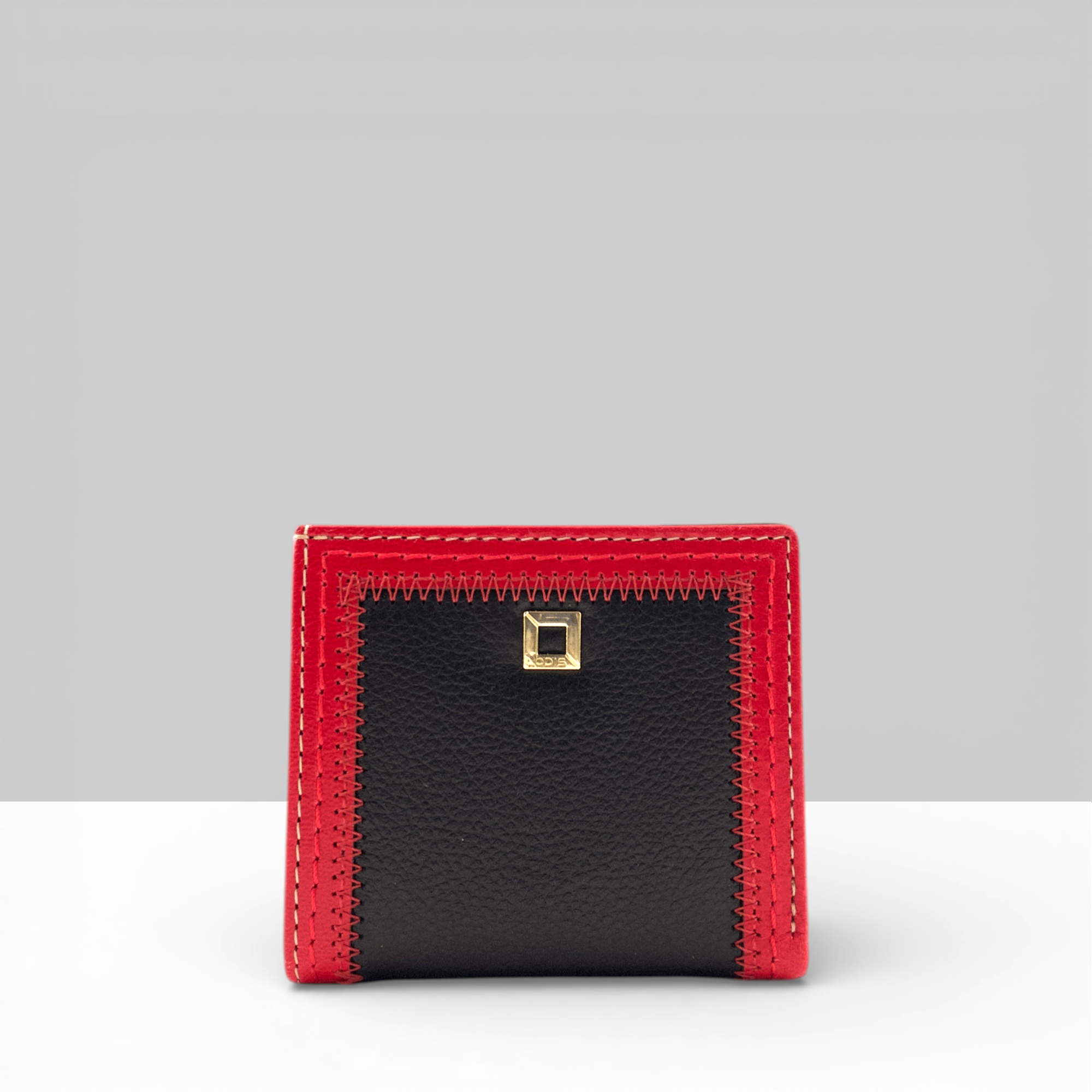 Cafe Slim Wallet in Black Leather with Rhythmic Red Contrast Stitching – Front View with Gold Square Snap Closure | Lodis 1965